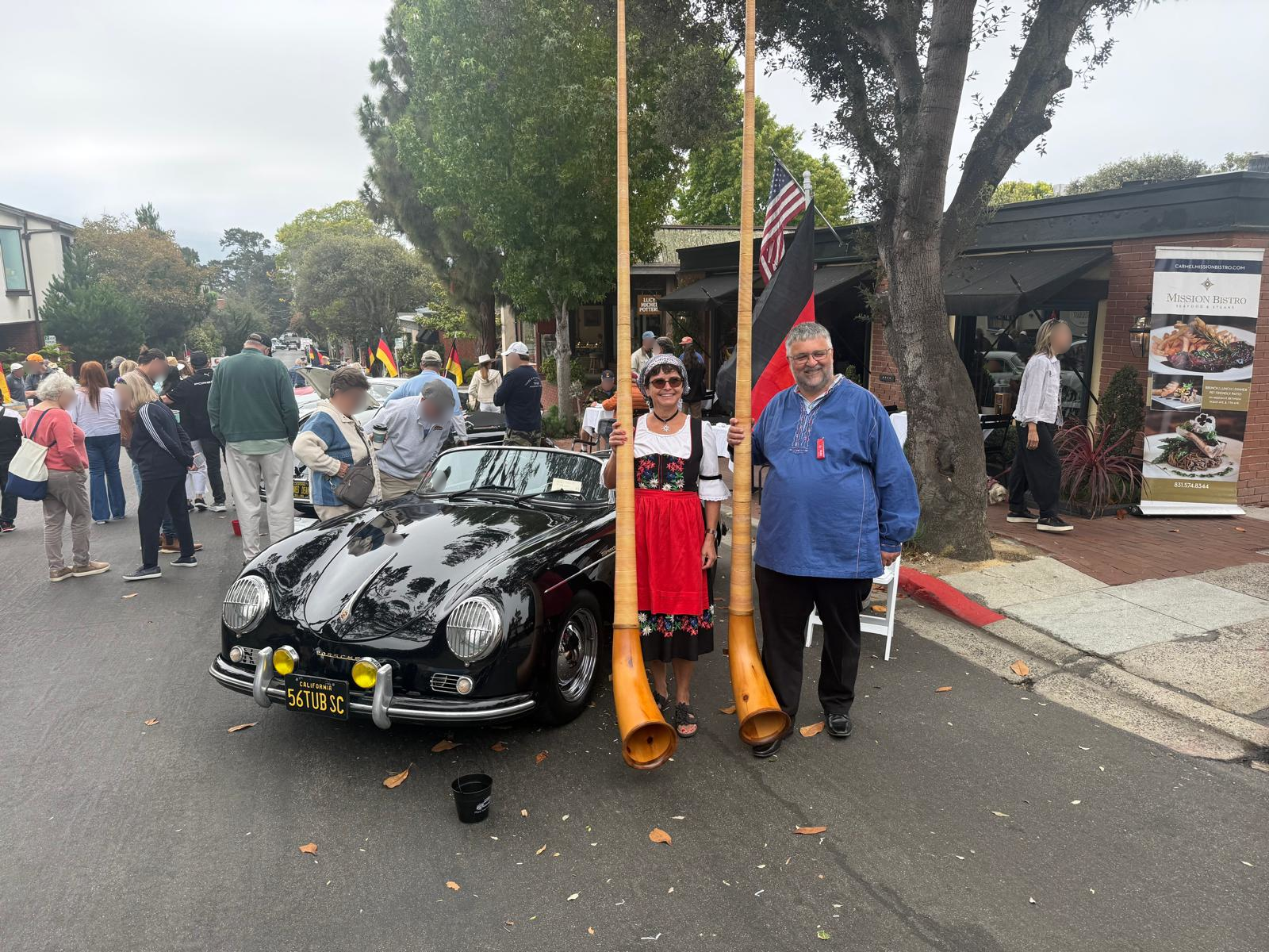 Alphorns in front of a classic car